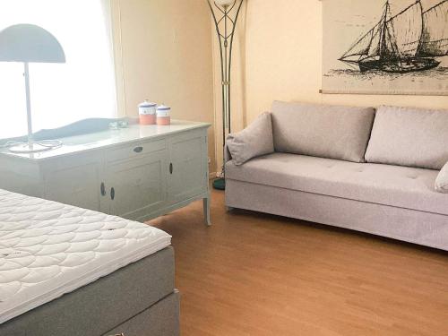 a living room with a couch and a dresser at 4 person holiday home in STENINGE in Steninge