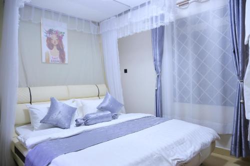Postel nebo postele na pokoji v ubytování AG Home - Kampala