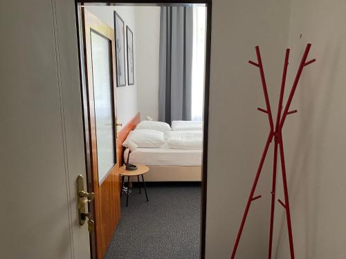 a room with a mirror and a bedroom with a bed at B&B Villa Hotel in Mariánské Lázně