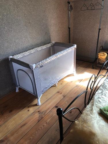 a bed sitting on top of a wooden floor at Sweet Honey homestay in Jūrmala
