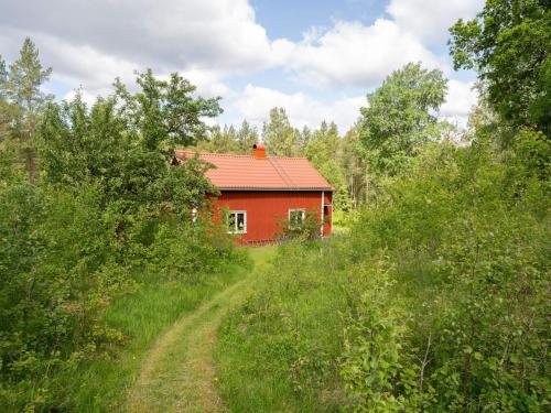 a red house in the middle of a field at 6 person holiday home in SANDHULT-By Traum in Sandhult