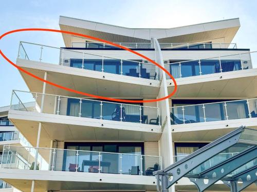 a red circle on the side of a building at Cozy Modern Apartment with Sea Views in Wendtorf