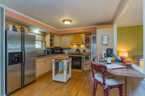 a kitchen with a stainless steel refrigerator and a table at The Place Between The Lakes 4 Bedrooms 4 Beds in Old Hickory