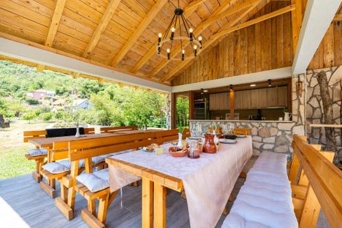 an outdoor dining room with a table and benches at NAJ village in Cetinje