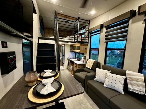 a living room with a couch and a table at The Loft | Creekside in Mansfield