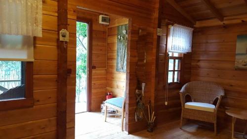 a room with wooden walls and a room with a table and chairs at Portalimo Lodge Hotel - Adult Only +12 in Cıralı