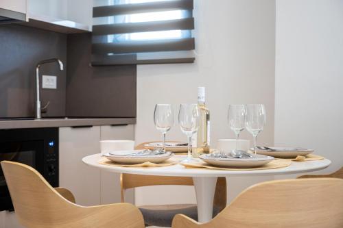 a table with glasses and plates on it in a kitchen at Unicos City Suites in Kos Town