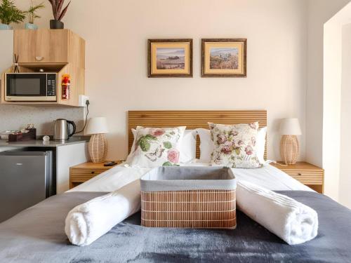 a bedroom with a large bed with a wooden headboard at Amalfi Place in Pretoria