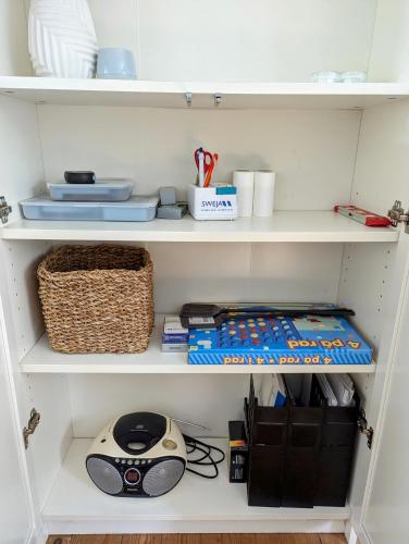 a shelf with a computer mouse and other items on it at Boats stay play lake cabin in Broby