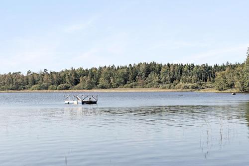 a boat in the middle of a large lake at Boats stay play lake cabin in Broby