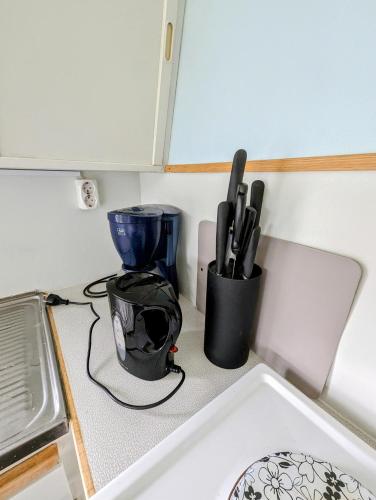 a kitchen counter with a sink and a cup at Boats stay play lake cabin in Broby