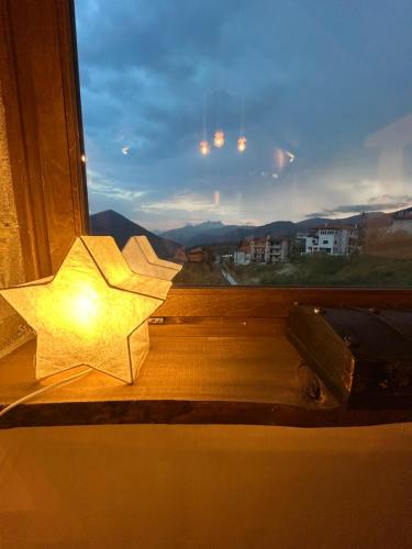a star on a window sill with a light at The House in the Cobbled Road in Karpenision