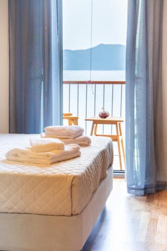 a bed with towels on top of it in a room at Selana και Ielios Trikerisuites in Tríkeri