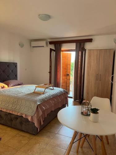 a bedroom with a bed and a table and a table at Apartmani Gazivode in Budva