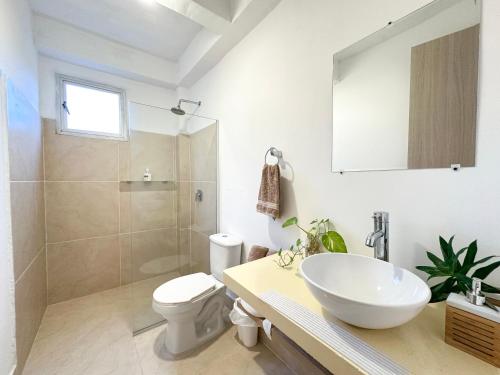 a bathroom with a sink and a toilet and a shower at Apartment for 6 Guests in Sabanilla a Few Steps from the Sea in Maizal