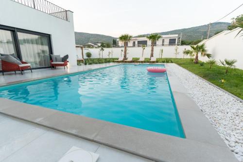 a swimming pool in the backyard of a house at Villa Alba - Countryside Hideway Between Mostar & Blagaj 