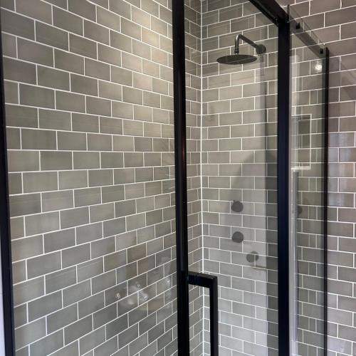 a shower with a glass door in a bathroom at No 6 Harrogate Luxury Boutique Home in Harrogate