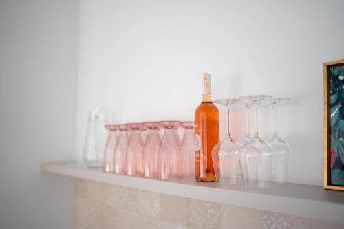 a shelf with glasses and a bottle on it at Villa Alba - Countryside Hideway Between Mostar & Blagaj 