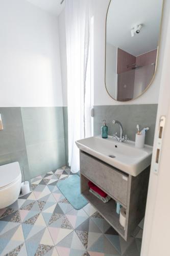 a bathroom with a sink and a mirror and a toilet at Villa Alba - Countryside Hideway Between Mostar & Blagaj 