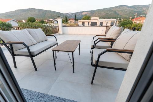 a group of chairs and a table on a balcony at Villa Alba - Countryside Hideway Between Mostar & Blagaj 