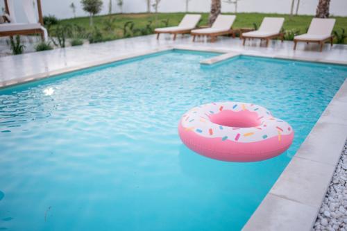a swimming pool with a donut float in the water at Villa Alba - Countryside Hideway Between Mostar & Blagaj 