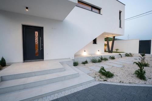 a house with a staircase leading up to a door at Villa Alba - Countryside Hideway Between Mostar & Blagaj 