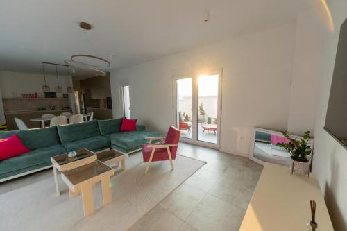 a living room with a green couch and a table at Villa Alba - Countryside Hideway Between Mostar & Blagaj 