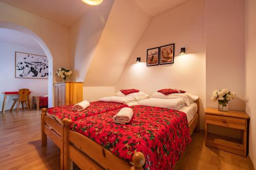 a bedroom with two dogs laying on a bed at Pokoje Gościnne Góraleczka in Szaflary