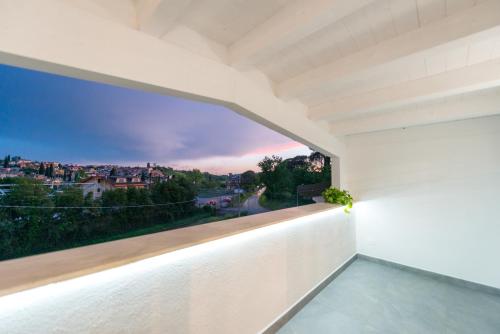 a view from the balcony of a house with a large window at Just Relax Home in Le Casette