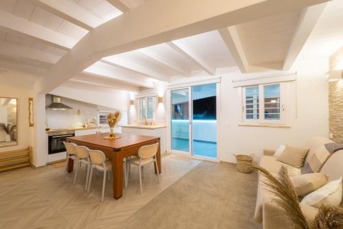 a living room with a table and a couch at Just Relax Home in Le Casette