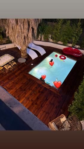 une piscine avec des coeurs rouges sur une terrasse en bois dans l'établissement Villa Salamandre, à Cannes