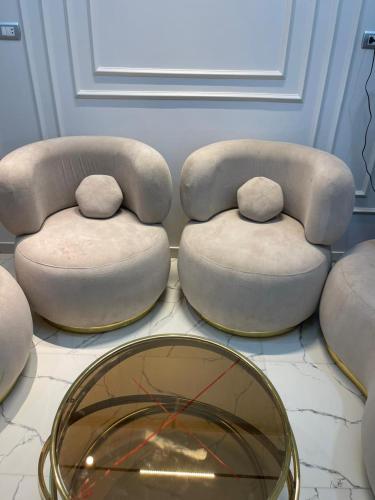 a room with two chairs and a table and a mirror at Eshyan Guest House in Aswan