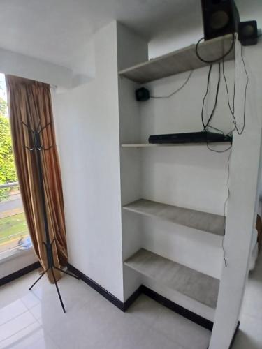 a room with stairs in a room with a window at Hotel Plaza Norte Cali in Cali