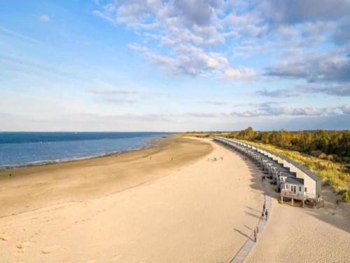 a view of a beach with people walking on it at Holiday Home Wissenkerke near Lake Veere in Wissenkerke