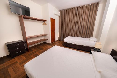 Giường trong phòng chung tại Paraiso Wasi