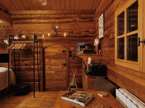 a room with wooden walls and a room with a table at Mazot du Bois in Les Houches