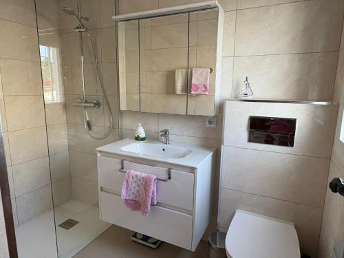 a bathroom with a sink and a shower and a toilet at Ideal pool chalet WBR in La Mata