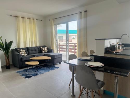a living room with a couch and a table and chairs at serena villague in Punta Cana