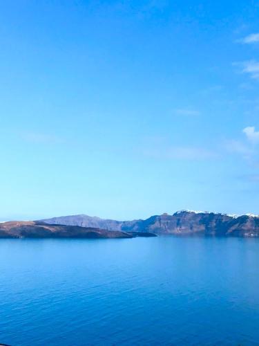 a view of a large body of water at Acrothea Suites and Villas - Akrotiri Caldera - Santorini in Akrotiri