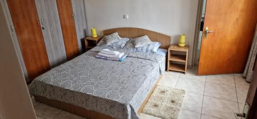 a bedroom with a bed with towels on it at Casa Dorului in Mangalia