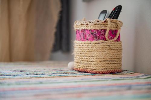 a crochet bag with a pair of scissors in it at B&B Steddueoro in Baunei