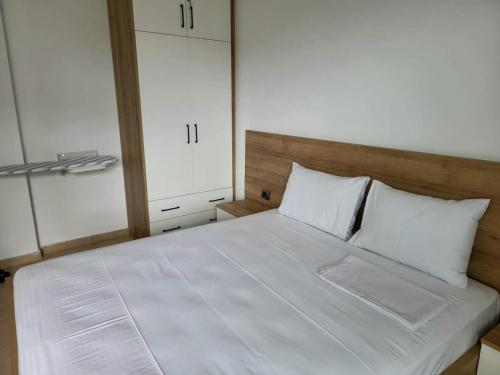 a bedroom with a large white bed with white pillows at 2F Saranda Apartment 3 in Sarandë
