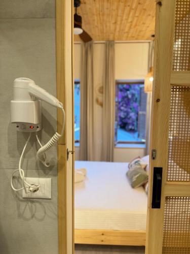 a hospital room with a phone on the wall at Old Town Suites Muradie in Vlorë