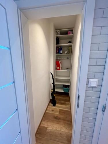 a hallway with a book shelf and an umbrella at Exclusive 2-room apartment in Nitra in Nitra