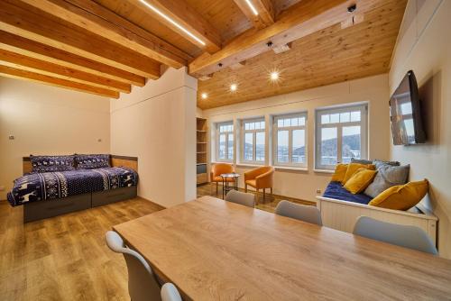 a room with a table and a bed and a bedroom at Urlas Apartments, dog friendly, shortcut to Sněžka Mountain in Pec pod Sněžkou