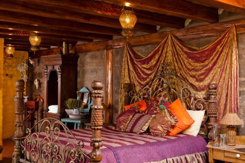 a bedroom with a bed with a canopy at Hacienda Rumiloma in Quito