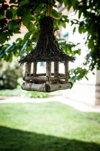 a bird feeder is hanging from a tree at Lichtenštejnské domky in Lednice