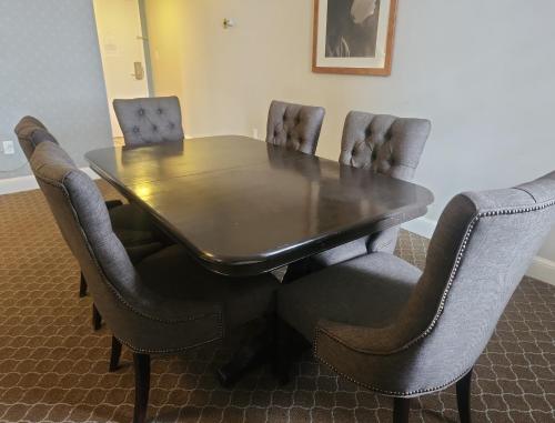 a dining room table and chairs with a table and a table and chairsuggest at Natural Bridge Hotel, Trademark Collection by Wyndham in Natural Bridge