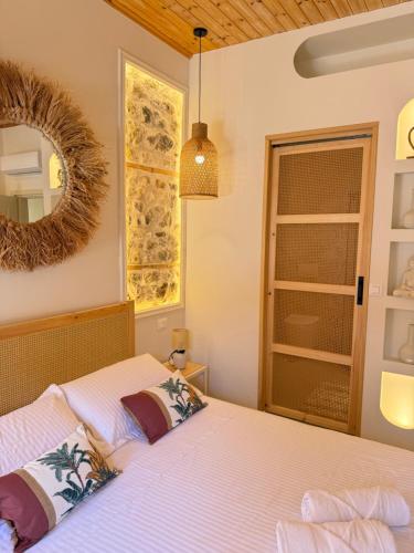 a bedroom with a bed and a mirror at Old Town Suites Muradie in Vlorë