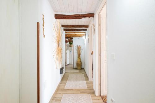 a hallway with white walls and a white ceiling at B&B Steddueoro in Baunei